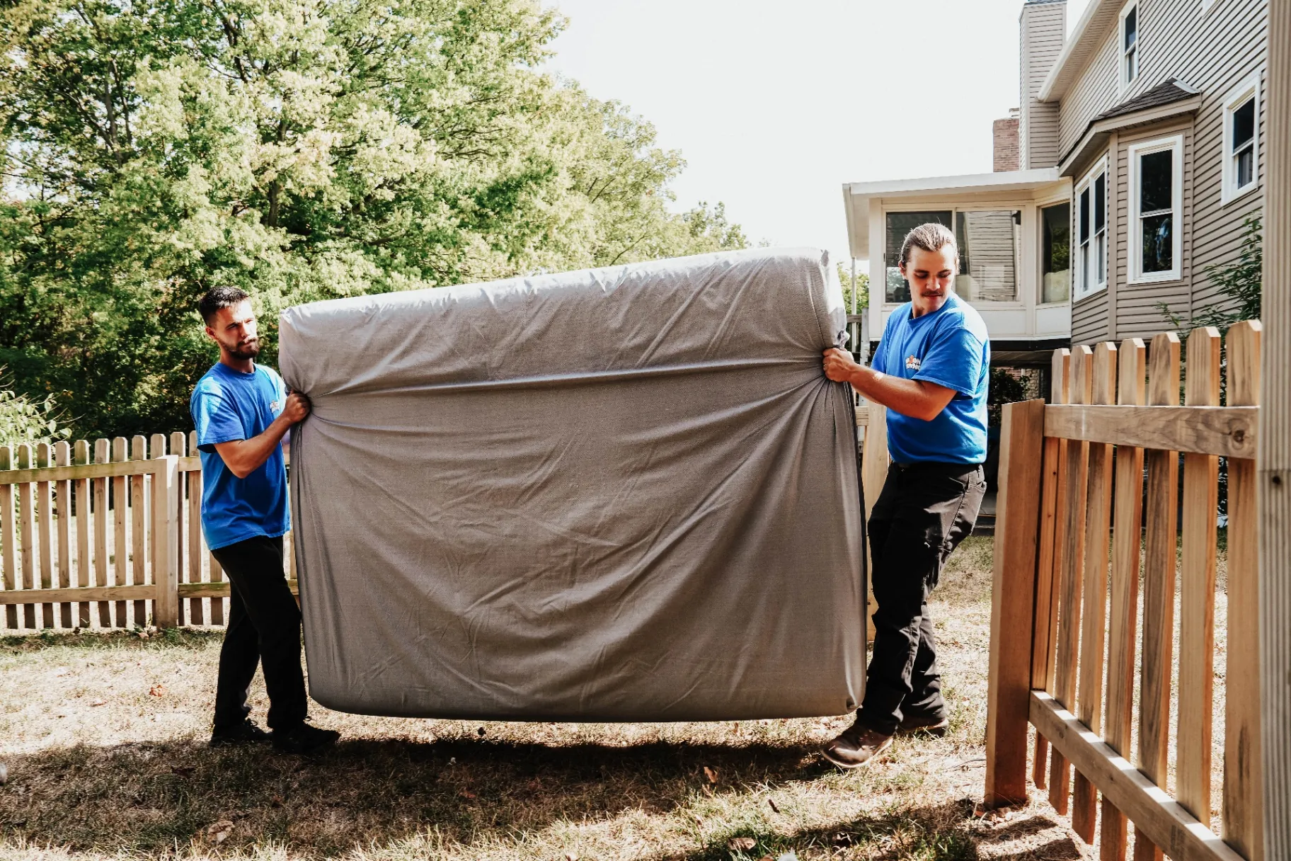 Professional movers carefully handling furniture during a local move