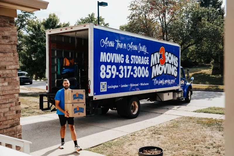 Professional movers carefully loading boxes into a moving truck